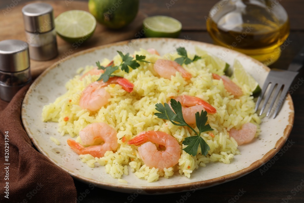 Delicious risotto with shrimps and parsley on wooden table, closeup Delicious risotto with shrimps and parsley on wooden table, closeup