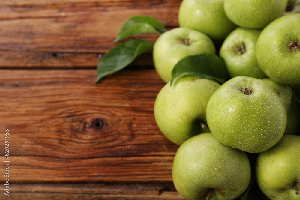 Fresh ripe green apples with water drops on wooden table. Space for text Fresh ripe green apples with water drops on wooden table. Space for text