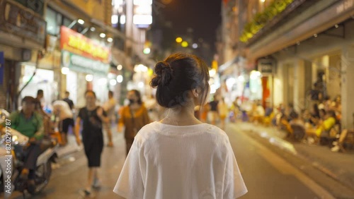 Portrait of happy Asian Vietnamese woman travel at night market people walking street fair in Hanoi city, Vietnam. Retail shops