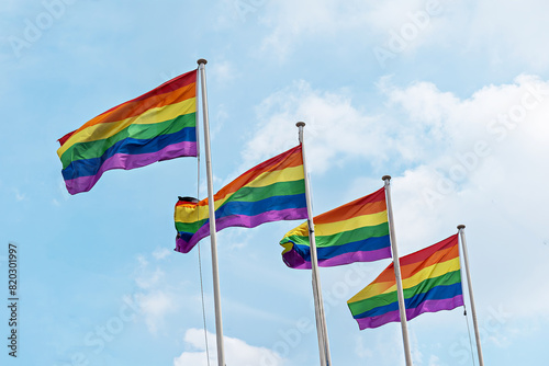 Rainbow flags, Flag for LGBT, LGBTQ or LGBTQIA+ Pride, The rainbow LGBTQ flags flies in the blue sky