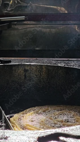 Close-up vertical video of unrecognizable person making harian churros in oil 4