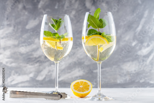 Refreshing Hugo Spritz Cocktail with Elderflower Cordial and Sparkling Wine in Glasses on Concrete