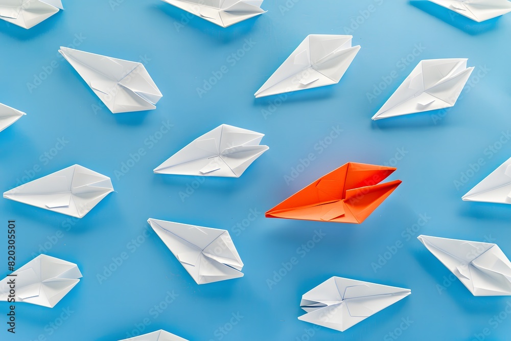 Red Paper Boat Leading Among White Boats on Blue Background Red Paper Boat Leading Among White Boats on Blue Background
