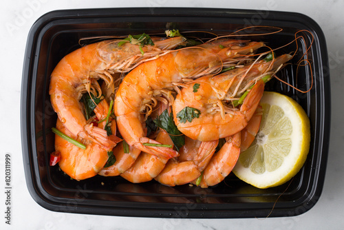 Chinese take out food cooked shrimp with lemon in a container