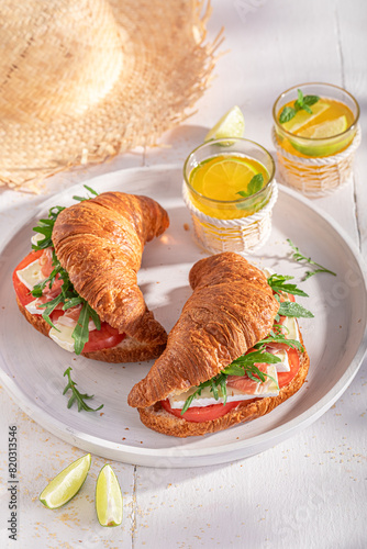 Fresh french croissant made of ham, cheese and vegetables.