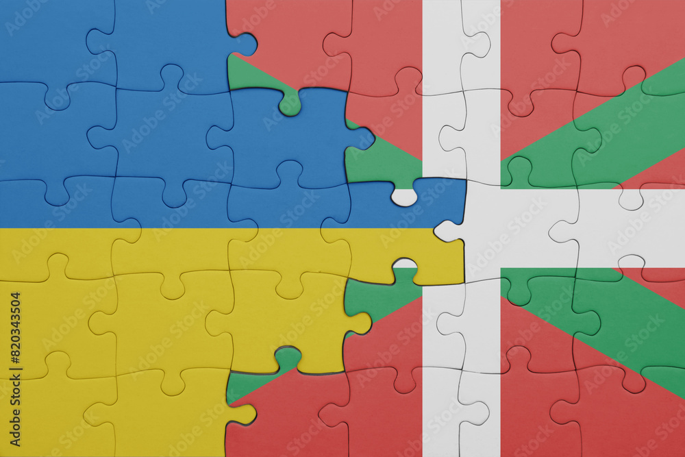 puzzle with the colourful national flag of basque country and flag of ukraine. puzzle with the colourful national flag of basque country and flag of ukraine.