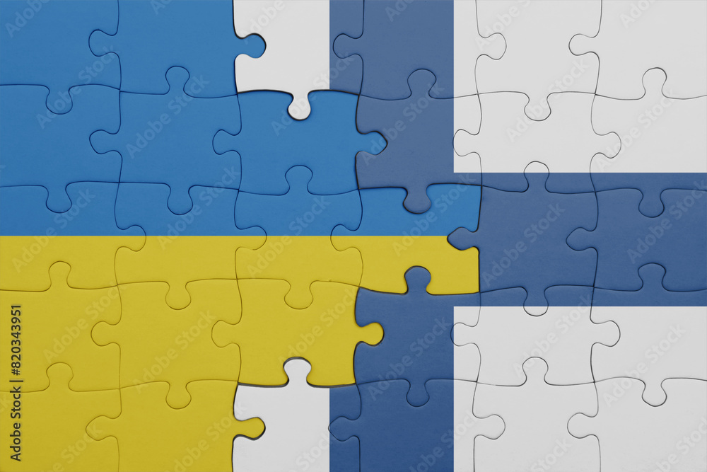puzzle with the colourful national flag of finland and flag of ukraine. puzzle with the colourful national flag of finland and flag of ukraine.