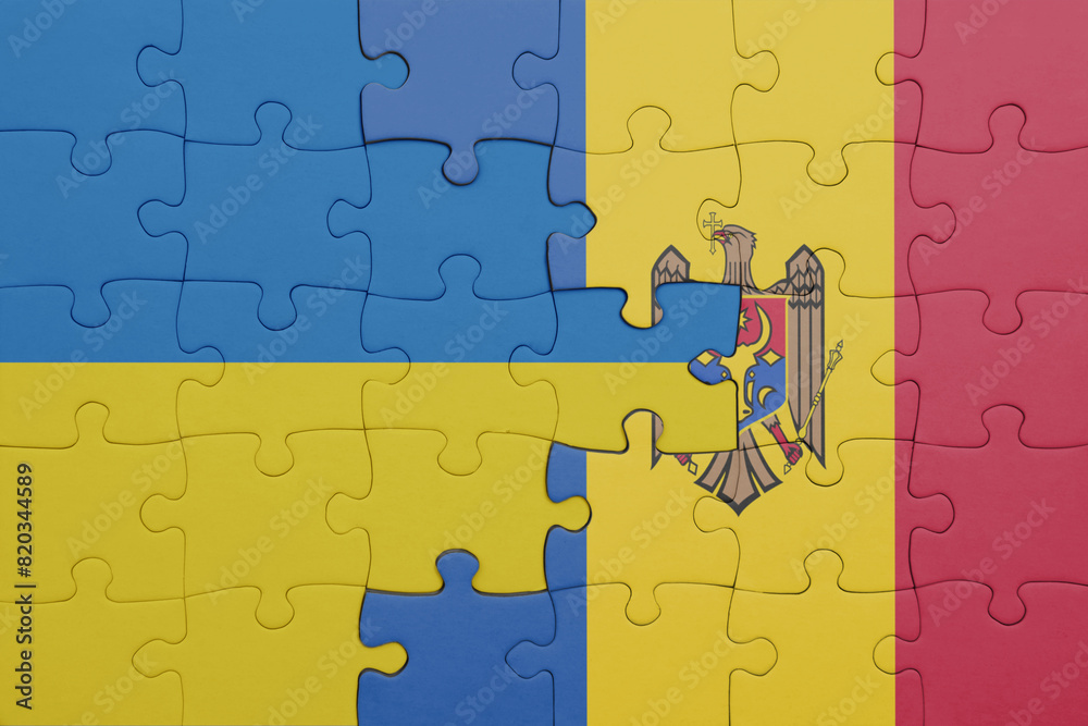 puzzle with the colourful national flag of moldova and flag of ukraine.
