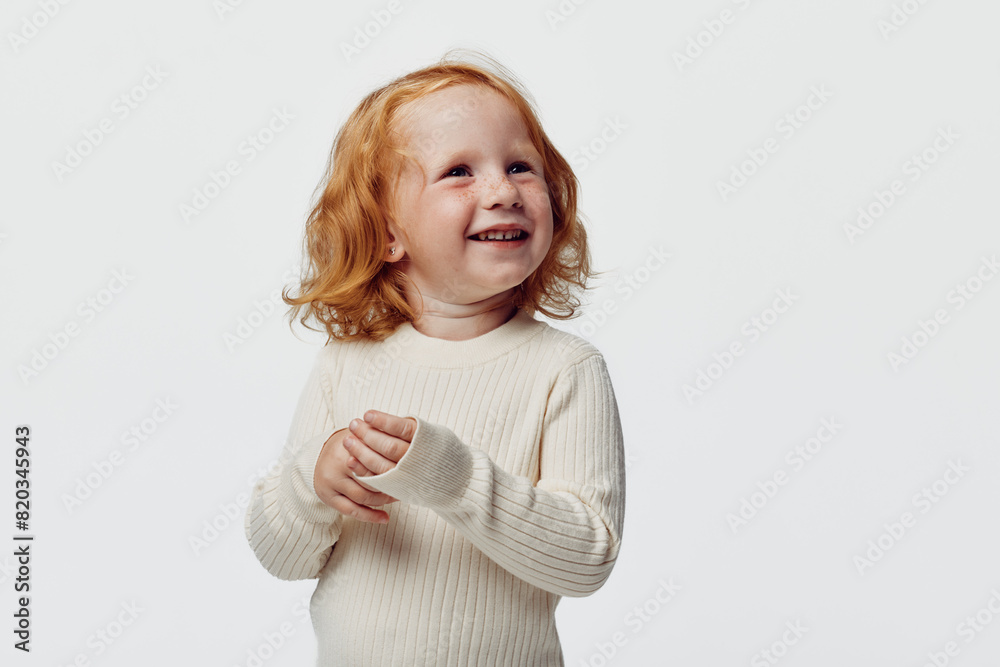 Happy redhaired girl standing in front of white background with smiling face as beauty portrait concept Happy redhaired girl standing in front of white background with smiling face as beauty portrait concept