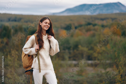 Mountain Adventure: Smiling Woman Enjoying Outdoor Cliff Hiking