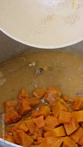 vertical video of step-by-step preparation of traditional Argentine food for national holidays at a family reunion with a huge pot for many portions 23