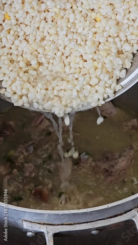 vertical video of step-by-step preparation of traditional Argentine food for national holidays at a family reunion with a huge pot for many portions 19