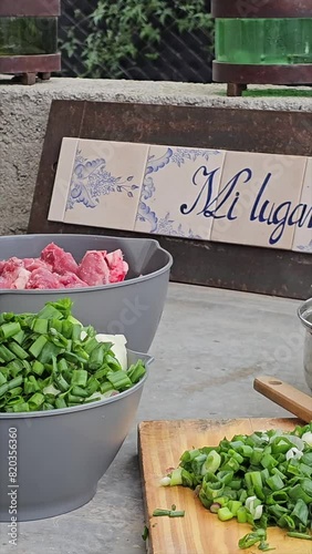 vertical video of step-by-step preparation of traditional Argentine food for national holidays at a family reunion with a huge pot for many portions 15