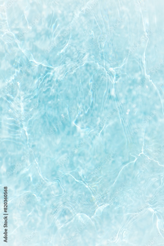 Blue water with ripples on the surface. Defocus blurred transparent blue colored clear calm water surface texture with splashes and bubbles. Water waves with shining pattern texture background. Blue water with ripples on the surface. Defocus blurred transparent blue colored clear calm water surface texture with splashes and bubbles. Water waves with shining pattern texture background.