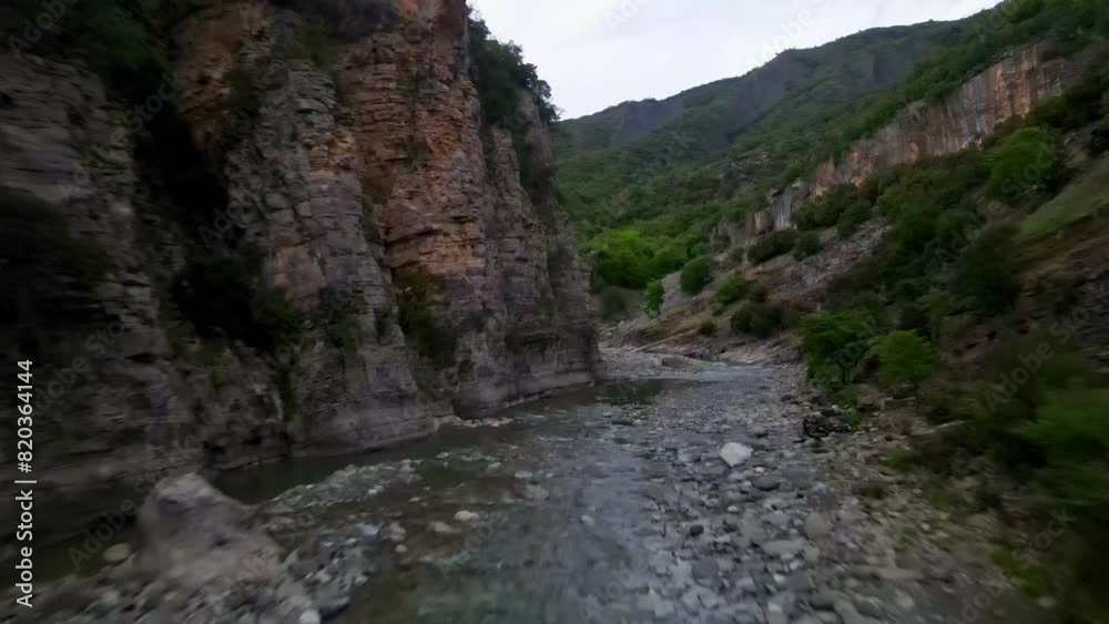 River bed between rocks. Benja Thermal Baths in Albania. Natural hot springs from a low flying drone River bed between rocks. Benja Thermal Baths in Albania. Natural hot springs from a low flying drone