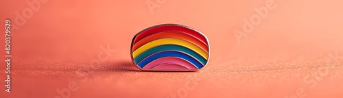 a enamel pin about LGBT Pride on a plain color background,muted colors photo