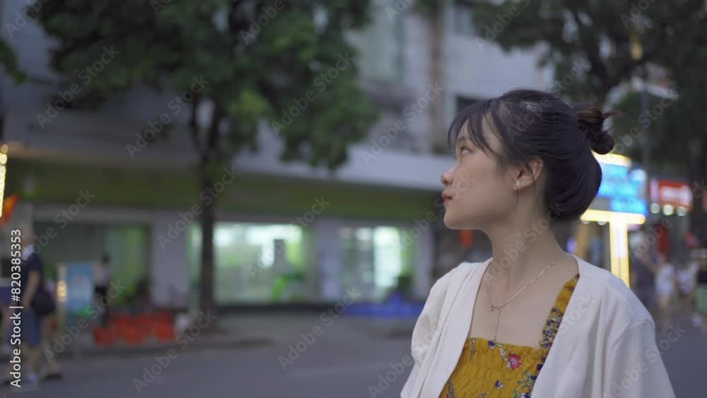 Asian Vietnamese woman walking on the street in Hanoi urban city town, Vietnam. Asian Vietnamese woman walking on the street in Hanoi urban city town, Vietnam.