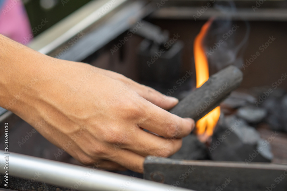 Hand of a man preparing a barbecue at home Hand of a man preparing a barbecue at home