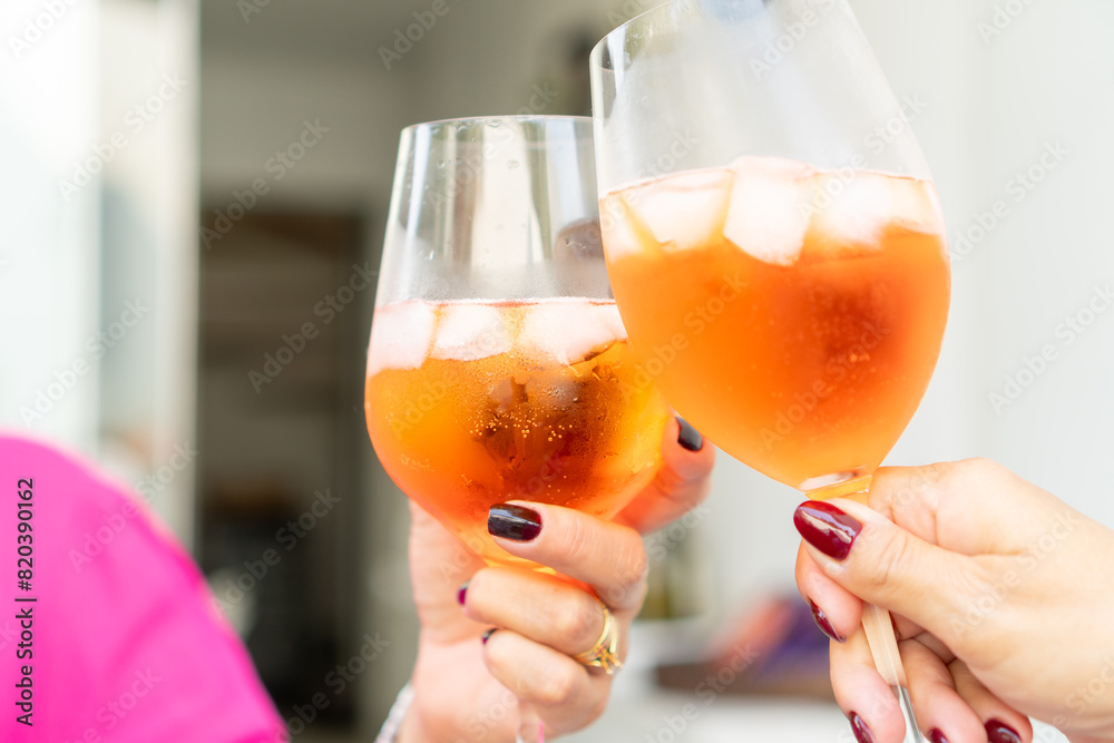 Fototapeta premium People toasting with cocktails in the garden