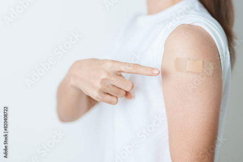 Woman with bandage after receiving vaccine. Vaccination and Immunization for Influenza, HPV, Zoster, IPD, DTP or Diphtheria, Tetanus and Pertussis, MMR, Hepatitis B, Covid  and Varicella vaccine photo