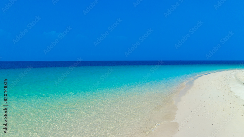 Nature of the beach and sea Summer with sunshine, sandy beaches, clear blue waters sparkling against the blue sky. On an island with good ecology and environment Background for summer vacation concept Nature of the beach and sea Summer with sunshine, sandy beaches, clear blue waters sparkling against the blue sky. On an island with good ecology and environment Background for summer vacation concept