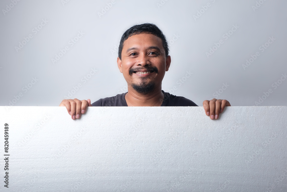 asian man holding blank sign, isolated in white background asian man holding blank sign, isolated in white background