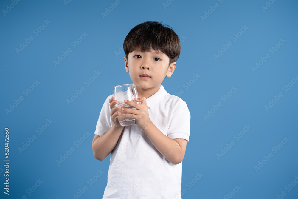 Portrait of asian boy posing on blue background Portrait of asian boy posing on blue background