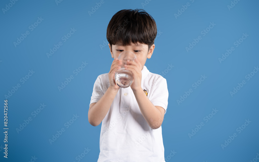 Portrait of asian boy posing on blue background Portrait of asian boy posing on blue background