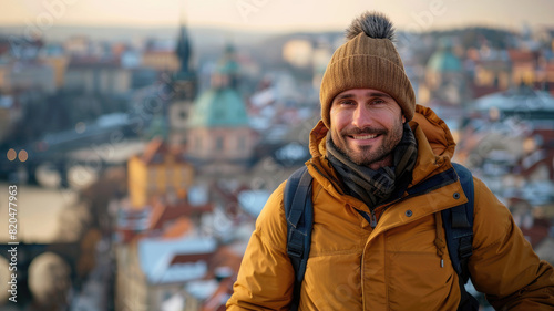 Happy male traveler wearing casual outdoor attire posing with a historical city view behind him