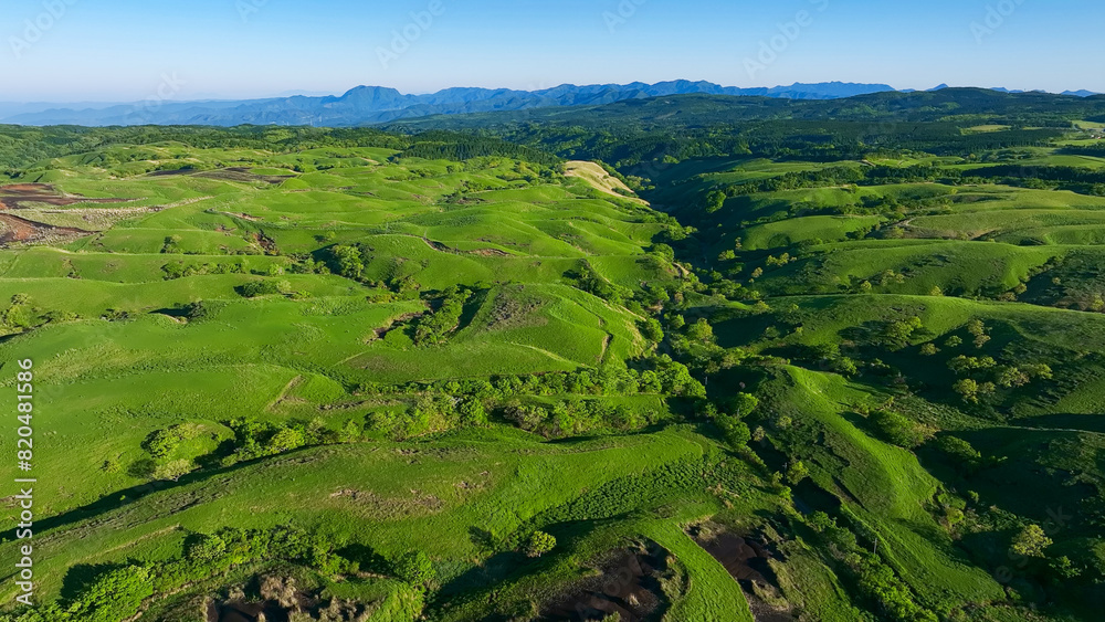 Drone aerial shots of spectacular greenery landscapes and blue sky. Dynamic natural scenery.