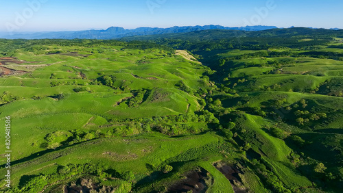 Drone aerial shots of spectacular greenery landscapes and blue sky. Dynamic natural scenery.