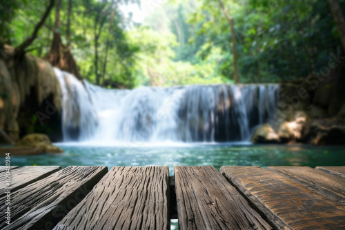 A wooden desk top with blurred background of waterfall. Good for background