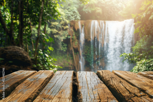 A wooden desk top with blurred background of waterfall. Good for background