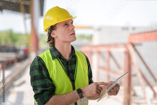 Engineer man with digital tablet checking project in the precast concrete factory site, Foreman worker at construction site