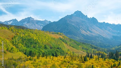 Timelapse, San Juan Mountains on Sunny Autumn Day, Forest in Yellow Green Foliage and Peaks, Colorado USA photo
