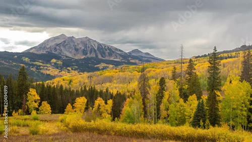 Timelapse, Clouds Moving Above Yellow Aspen Forest and Mountain Peak. Kebler Pass, Colorado USA photo