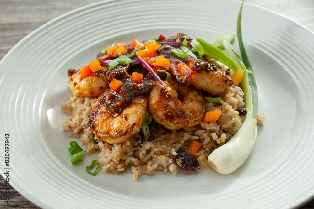 A view of a plate of brown stew shrimp. A view of a plate of brown stew shrimp.