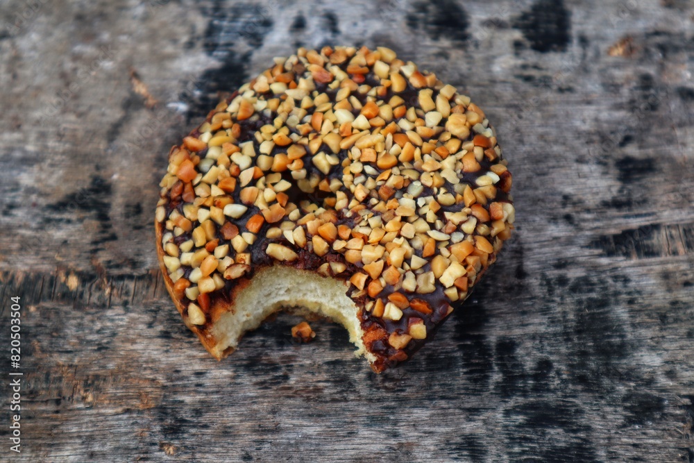 Donuts with peanut and chocolate topping on top close up. Donuts with peanut and chocolate topping on top close up.