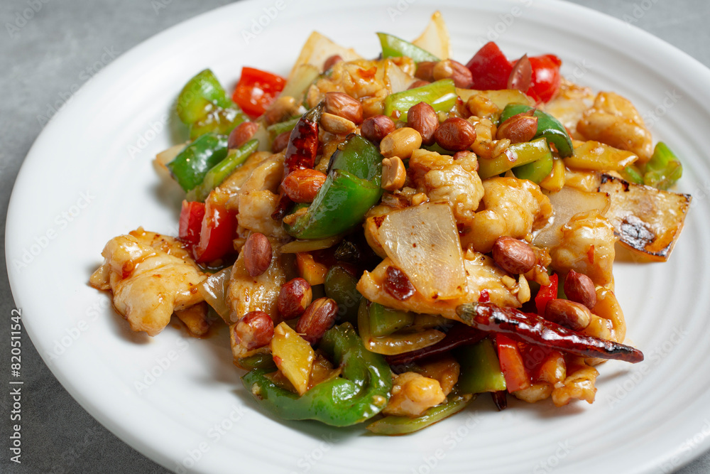 A closeup view of a plate of kung pao chicken. A closeup view of a plate of kung pao chicken.