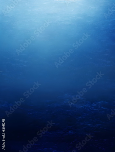 A blue ocean with no visible objects. The water is calm and peaceful. The sky is clear and bright, and the sun is shining down on the water. Concept of tranquility and serenity