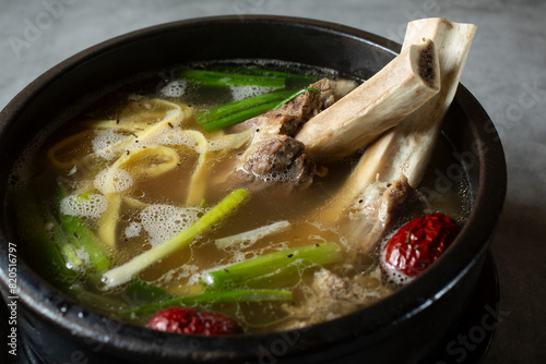 A closeup view of a bowl of bone-in beef short rib soup. photo