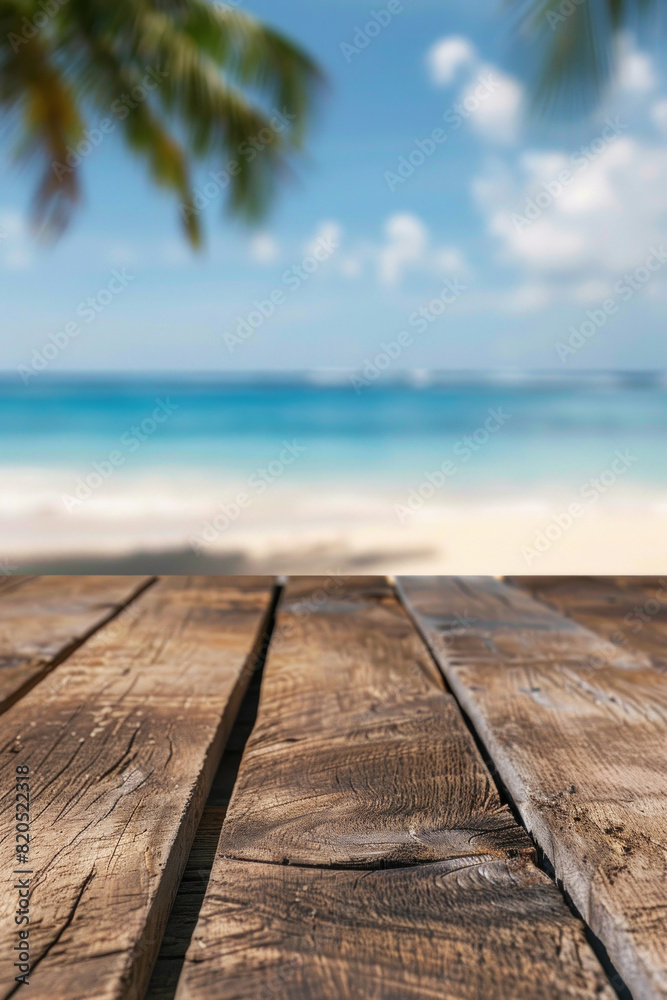 Fototapeta premium A wooden desk top with blurred background of beach. Good for background 