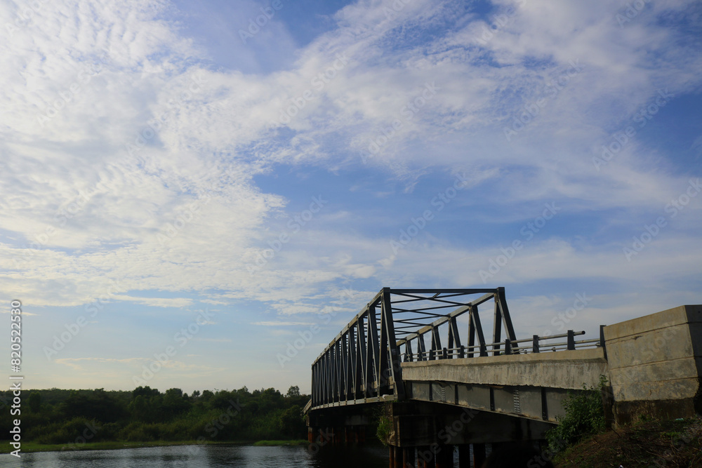 clouds with Calm weather over the water. Ocean with clouds on a background of green trees and blue sky clouds with Calm weather over the water. Ocean with clouds on a background of green trees and blue sky