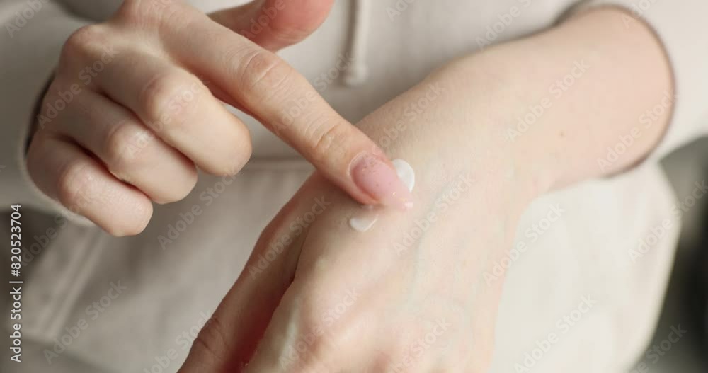 Applying moisturizer to skin of wrist Applying moisturizer to skin of wrist