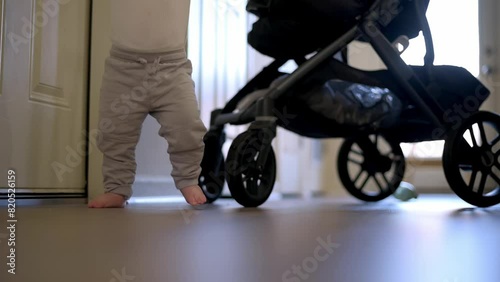the tiny, bare feet of a one-year-old child as they take tentative steps, marking a significant milestone in the journey of growth and motor development. photo