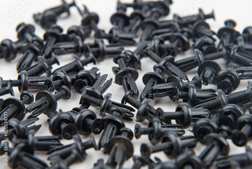 Black plastic clips for attaching car trim parts.