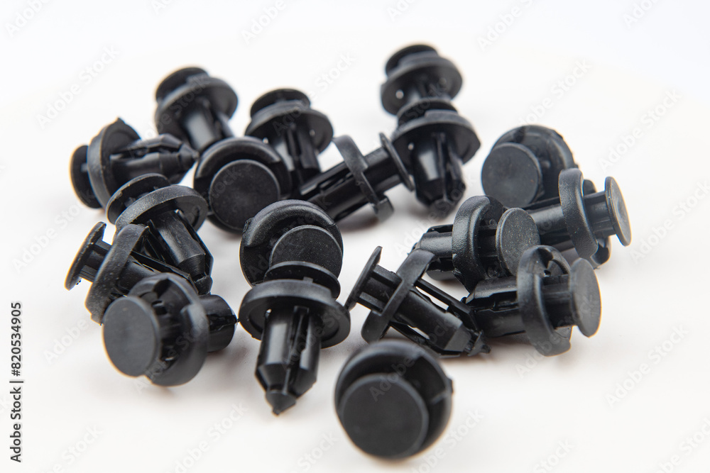 Black car body plastic push pin fasteners. On white isolate. Black car body plastic push pin fasteners. On white isolate.