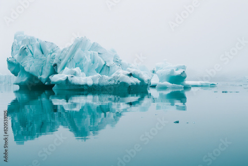 A tranquil icy landscape with icebergs in clean white and blue color tone.  © grey