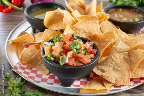 A view of a tray of chips and salsa.