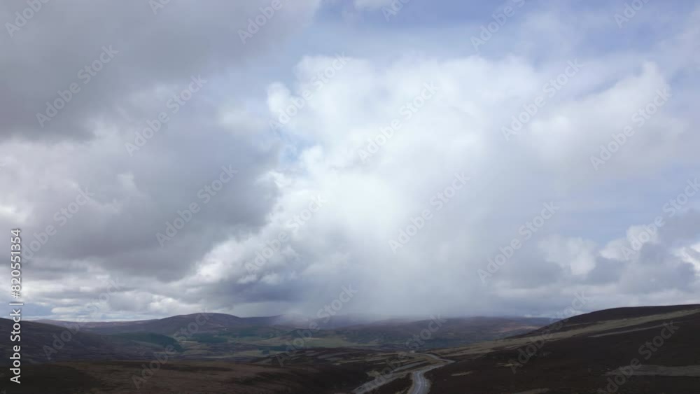 Slow aerial descending over The Cairngorms, rain cloud in background, Scotland Slow aerial descending over The Cairngorms, rain cloud in background, Scotland